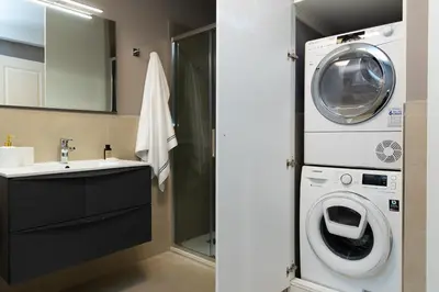 a bathroom with a washing machine and a sink at Amazing 3-Bedrooms Pantheon in Rome