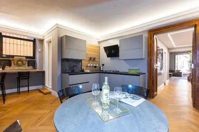 a dining room with a table with wine glasses on it at Amazing 3-Bedrooms Pantheon in Rome