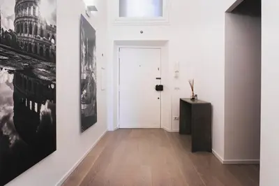 a hallway with black and white pictures on the wall at Exclusive apartments piazza di spagna 32 in Rome