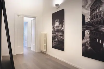 a hallway with two posters on the wall and a hallway at Exclusive apartments piazza di spagna 32 in Rome