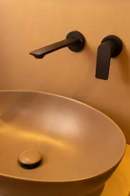 a white sink with a black faucet on the wall at Exclusive apartments piazza di spagna 32 in Rome
