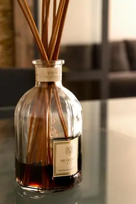 a bottle of whiskey with sticks in it on a table at Exclusive apartments piazza di spagna 32 in Rome