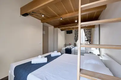 a bedroom with two bunk beds with white sheets at A casa di Roberta in Rome