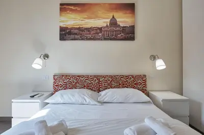 a bedroom with a bed with a picture on the wall at A casa di Roberta in Rome