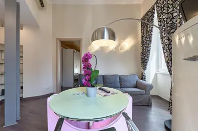 a living room with a table and a couch at A casa di Roberta in Rome