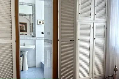 a bathroom with a sink and a toilet and a mirror at Penthouse with terrace - Vatican Museums, Saint Peter's in Rome