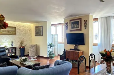 a living room with a couch and a tv at Penthouse with terrace - Vatican Museums, Saint Peter's in Rome