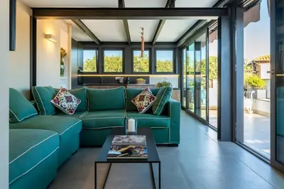 a living room with a green couch and a table at Della Vittoria Penthouse in Rome