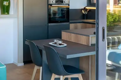 a small kitchen with a table and chairs at Della Vittoria Penthouse in Rome