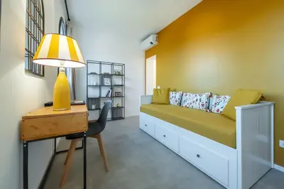 a bedroom with a bed and a desk and a lamp at Della Vittoria Penthouse in Rome