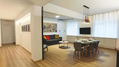 a living room and dining room with a table and a couch at RomeBestHome Scialoja - Piazza del Popolo in Rome