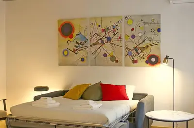 a bedroom with a bed with a painting on the wall at RomeBestHome Scialoja - Piazza del Popolo in Rome