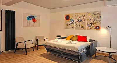 a bedroom with a bed and a table and chairs at RomeBestHome Scialoja - Piazza del Popolo in Rome