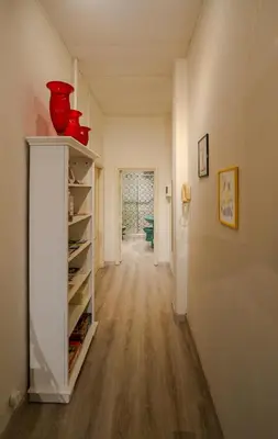 a hallway of a home with a red vase on a shelf at Le Caraffe ROMA - Parioli in Rome