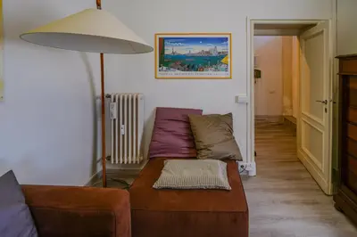 a living room with a couch and a lamp at Le Caraffe ROMA - Parioli in Rome