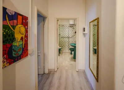 a hallway with a painting on the wall and a bathroom at Le Caraffe ROMA - Parioli in Rome