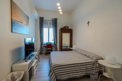 a bedroom with a bed and a television in it at Le Caraffe ROMA - Parioli in Rome
