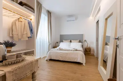 a white bedroom with a bed and a closet at La Maison du Charme in Rome