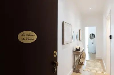 a hallway with a black door with a sign on it at La Maison du Charme in Rome