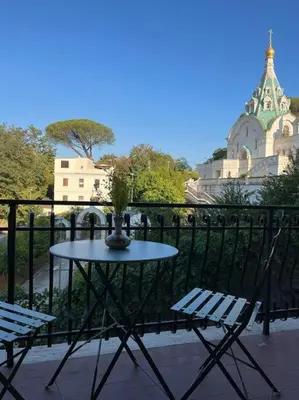 a table and two chairs on a balcony at Delizioso Monolocale con vista in Rome