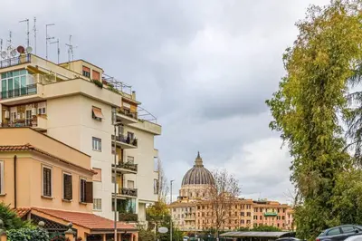 a building with a dome in the background of a city at Delizioso Monolocale con vista in Rome