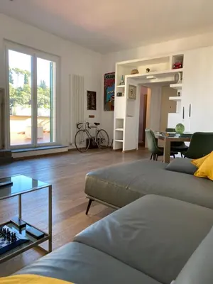 a living room with two beds and a table at Terrazza Flaminia in Rome