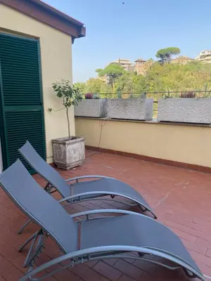 a pair of chairs sitting on a patio at Terrazza Flaminia in Rome