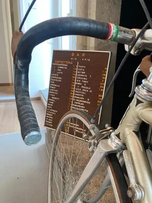 a bike parked next to a sign on a wall at Terrazza Flaminia in Rome