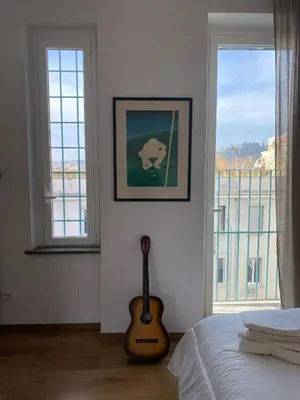 a bedroom with a guitar sitting next to a bed at Terrazza Flaminia in Rome