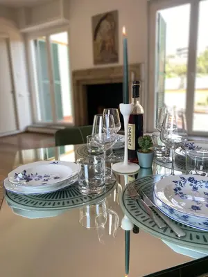 a glass table with a bottle of wine and glasses at Terrazza Flaminia in Rome