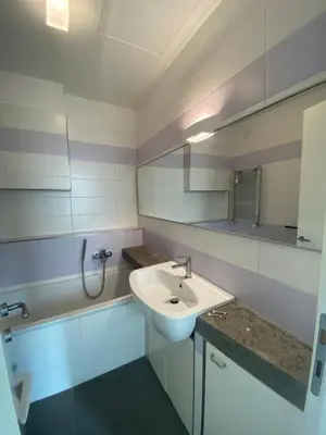 a white bathroom with a sink and a mirror at Terrazza Flaminia in Rome