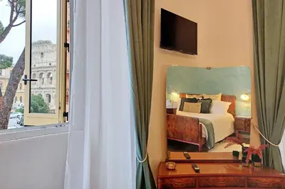 a bedroom with a bed and a large mirror at Romance al Colosseo 3 in Rome