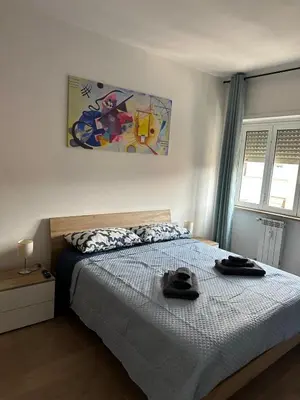 a bedroom with a bed with two hats on it at Alloggio turistico Gloria e Luigi in Rome