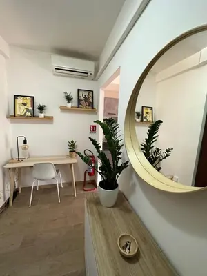 a living room with a mirror and a table at Alloggio turistico Gloria e Luigi in Rome