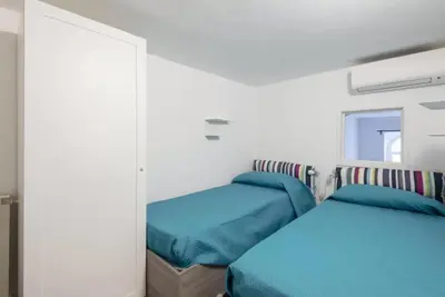 a bedroom with two beds and a mirror at Elegant loft at Piazza Vittorio in Rome
