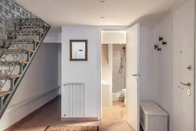 a hallway with a staircase and a bathroom at Elegant loft at Piazza Vittorio in Rome