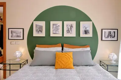 a bedroom with a green wall and a bed with pillows at Rome Family Comfort Hub in Rome
