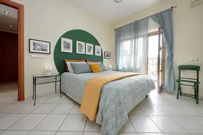 a bedroom with a large bed with a green headboard at Rome Family Comfort Hub in Rome