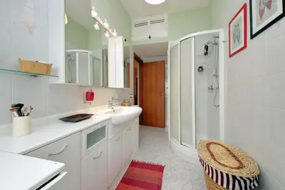 a white bathroom with a sink and a shower at Rome Family Comfort Hub in Rome