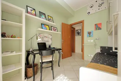 a room with a desk and a bed and a bedroom at Rome Family Comfort Hub in Rome