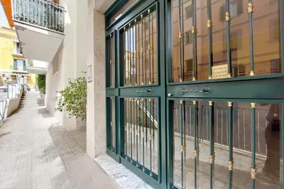 a store front with green doors and windows at Rome Family Comfort Hub in Rome