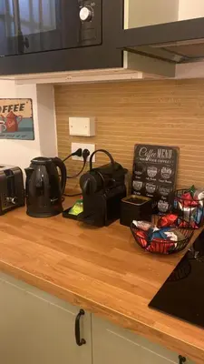 a kitchen counter top with a tea pot and a toaster at A due passi dal Colosseo in Rome