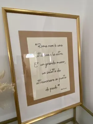 a framed picture of a sign in a mirror at A due passi dal Colosseo in Rome
