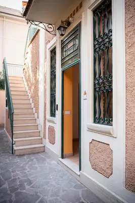 an orange door on a building with stairs at Lux of the Vatican in Rome