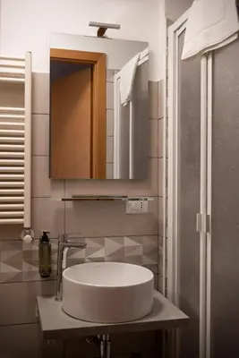 a bathroom with a sink and a mirror at Lux of the Vatican in Rome