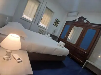 a bedroom with a bed and a table with a lamp at Vatican Treasure Garden in Rome