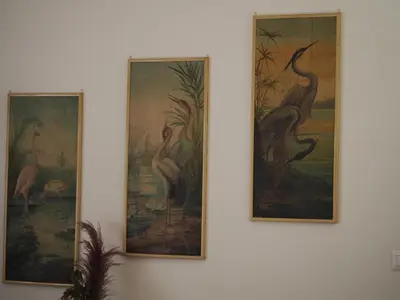 three framed paintings of birds on a wall at Vatican Treasure Garden in Rome
