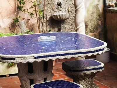 a table and two chairs sitting around a blue table at Vatican Treasure Garden in Rome
