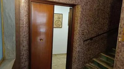 a wooden door in a room with a staircase at Vatican Treasure Garden in Rome