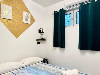 a bedroom with green curtains and a bed at CHANGE S house, Few stops from St Peter s in Rome